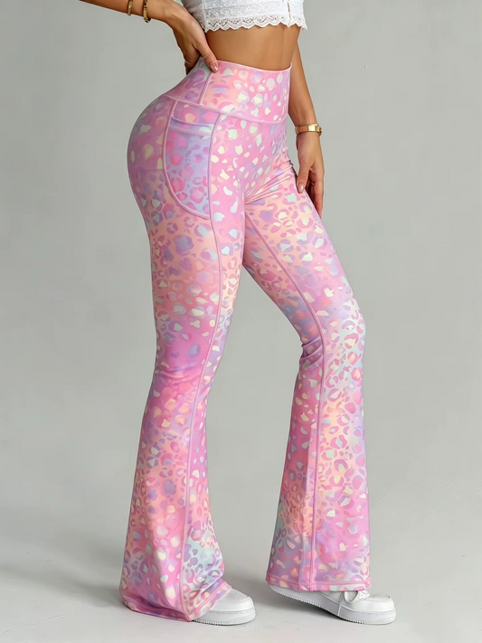 Pink leopard-print flare leggings with a subtle iridescent sheen, modeled from the waist down on a light gray background.